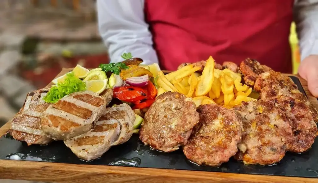 The ultimate Serbian meat platter, where the legendary pljeskavica holds court among other grilled masterpieces.